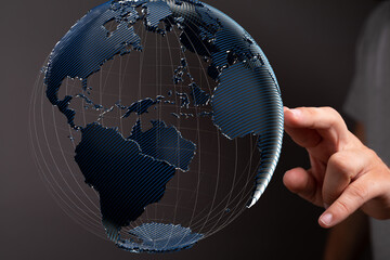 Abstract image of a hand interacting with a digital globe, representing global connectivity and...