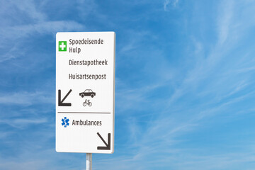 Route sign with the Dutch text for Emercengy care, Service pharmacy, GP family doctor medical centre and Ambulance
