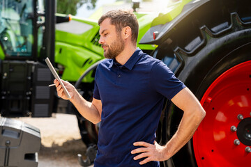 Professional reviewing lease agreement on digital device in agricultural and construction machinery...