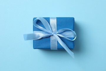 Beautiful gift box on color background, top view