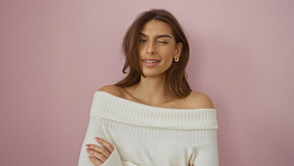 Woman winking with brunette hair against a pink background, showcasing beauty, elegance, and casual...
