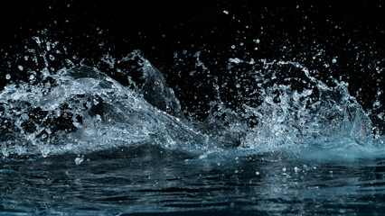 Clear water splash on a black background , close-up