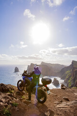 Enduro Motorcycle with Driver Posing on Sea Cliff , Madeira island