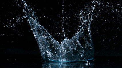 Clear water splash on a black background , close-up