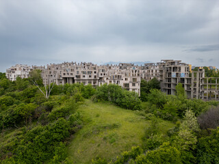 Abandoned hotel complex in Tsarevo, Bulgaria. Aerial view of decaying brutalist buildings overtaken by nature. Urban exploration, urbex, site with eerie, post-apocalyptic atmosphere.