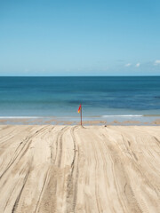 Life guard flag planted on beach recently prepared for summer