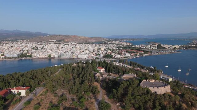 A cinematic drone reveal of Chalkida, showcasing the historic old Evripos bridge and the vibrant coastal cityscape along the Euboean Gulf.