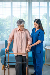 Senior elderly woman receiving walker assistance from female caregiver nurse at home