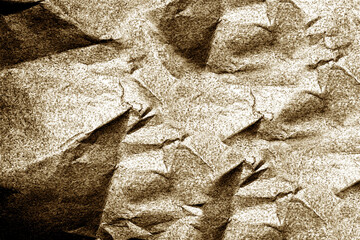 Crumpled paper creates textured background with light brown hues