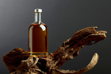 Bottle of whiskey on a old snags.