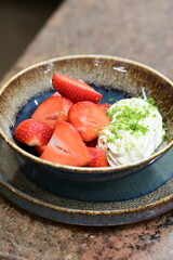 Fresh strawberries with mascarpone cheese served as fresh fruit – vibrant and creamy dessert with elegant food background