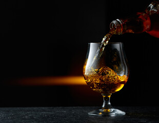 Brandy being poured into a glass.