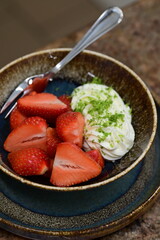 Fresh strawberries with mascarpone cheese served as fresh fruit – vibrant and creamy dessert with elegant food background