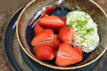 Fresh strawberries with mascarpone cheese served as fresh fruit – vibrant and creamy dessert with elegant food background
