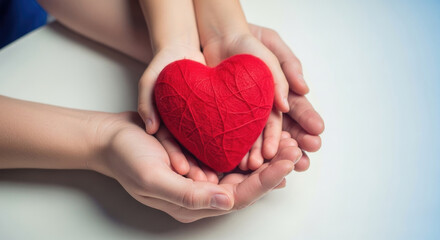 Gentle hands sharing a vibrant red heart symbolizing love care and compassion