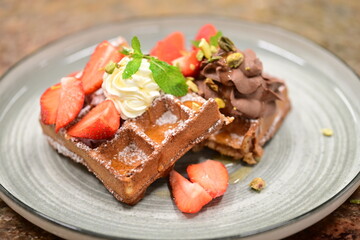 Portion of golden waffles (gofry) served on a plate, showcasing their crispy texture and inviting appearance