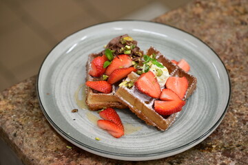 Portion of golden waffles (gofry) served on a plate, showcasing their crispy texture and inviting appearance