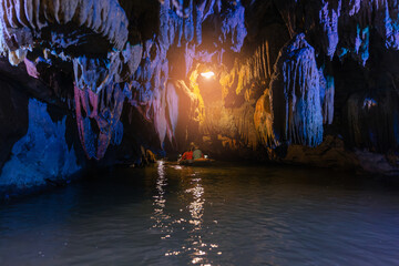Exploring scenic caves in Ninh Binh, Vietnam, stalactites and tranquil waters