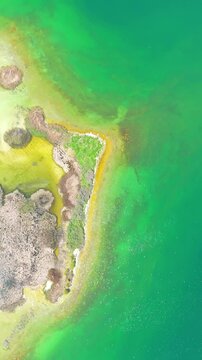 Scenic aerial drone image of a  island surrounded by white sand coastline. Chayei Island, Sevan, Armenia