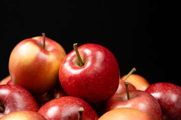 Group of fresh organic red whole apples on a black background