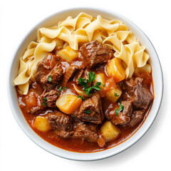 A bowl of beef goulash with fork-tender meat, potatoes, and a paprika-rich sauce, served with buttered noodles on the side.