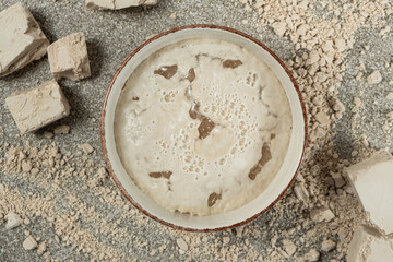 Fototapeta premium Activation of wet fresh yeast in warm water with sugar.