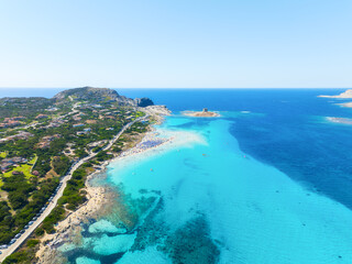 Beach La Pelosa, Sardinia, Italy. Summer vacation and rest. Beach, people and umbrellas. Top view from drone at the beach and azure sea. Background, wallpaper, postcards.