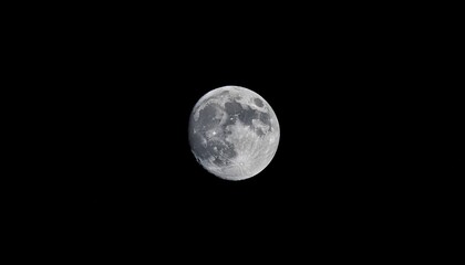 Fototapeta premium bright full moon illuminating the night sky against a deep black background
