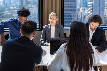 Team of diversity business people are discussing over new strategic strategy project on investment real estate while brainstorming around the office building for new project and planning