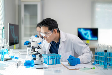 A man in a lab coat is writing on a clipboard