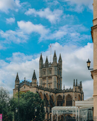 Naklejka premium Bath Abbey, England, UK against a cloudy blue sky.