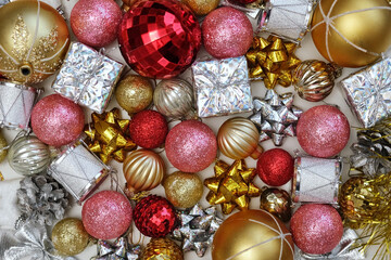 Christmas Ornaments Background Rotation, Spinning. Close up a Glitter Christmas Tree Decoration Items is Turning. Backdrop of New Year Ornate. Many Shiny Xmas Bauble, Balls and Bulbs. Top View, Frame