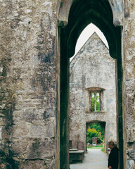 Man in ruins of Clare Abbey, Ireland.