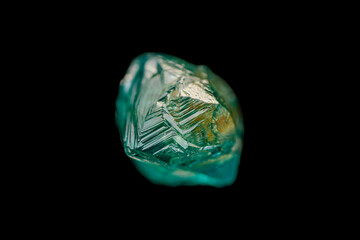Rare natural rough bicolor diamond crystal on dark background (selective focus)