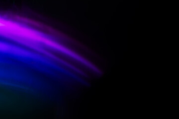 Abstract blurred colorful lens flare bokeh on black,