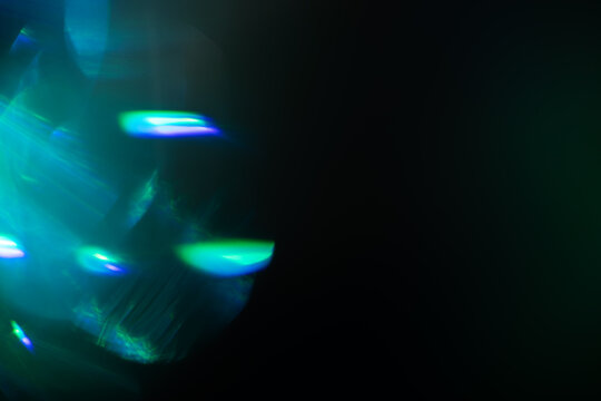 Blurred Light painting one exposure in camera. light glares with a spectral gradient on a dark background.