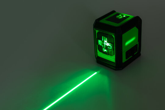 Green Laser level turned on in a dark room