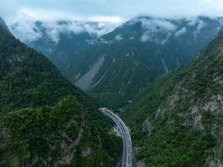 Aerial view of  beautiful foggy forest mountain and highway landscape