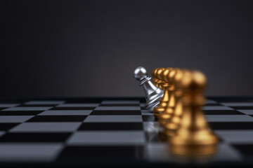 silver pawn chess on chess board move out from line for different thinking and leading change