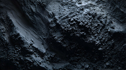 Fototapeta premium Dramatic close up of textured dark grey powder with shadows creating a moody abstract scene