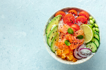 Poke bowl with salmon. Hawaiian salad with rice, fish, tomato, and avocado. Healthy diet. Overhead flat lay shot with copy space