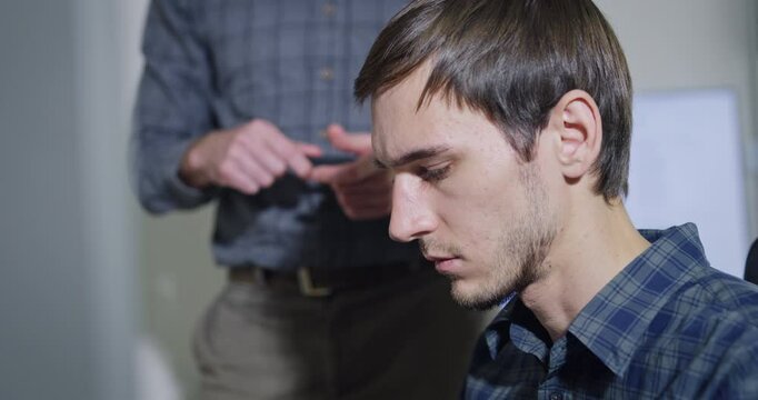 Closeup team adult male engineer collaborate on robotic hand project using AI code solutions machine learning at tech workspace. Artificial intelligence interface, collaboration prototype development.