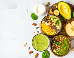 Two glasses of vibrant green smoothies sit at the center of a light-colored surface, flanked by a white cup of creamy liquid and two bowls with similar green mixtures, all arranged against a neutral b