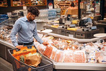 Searching for meal. Man is in the grocery store