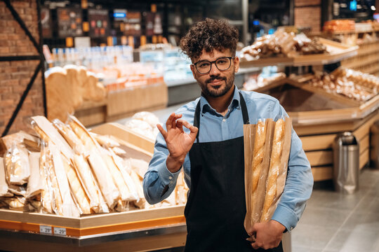 Fresh bakery. Male worker is in the grocery store