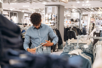 Blue jeans. Man customer is in the clothing store