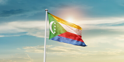 Comoros national flag waving in the sky with mast. 