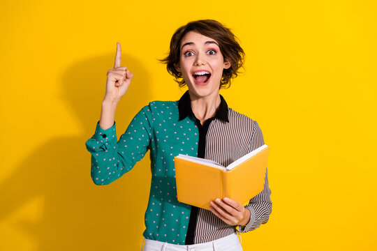 Photo of glad excited lovely woman wear stylish clothes finger up isolated on yellow color background