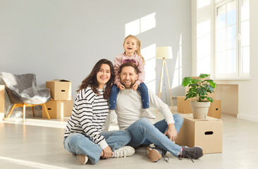 Family enjoys moving new apartment, happy mother, father, cute child near cardboards, excited homebuyer transporting boxes, organizing new home move, changing residence for better, independence