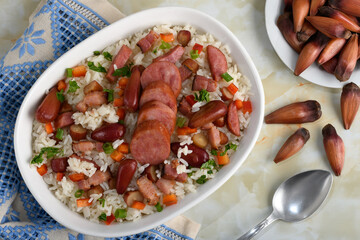 A delicious Brazilian dish of rice with sausage, bacon and pine nuts